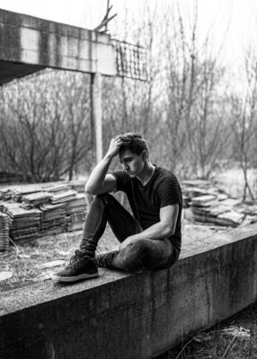 man sitting on concrete bench