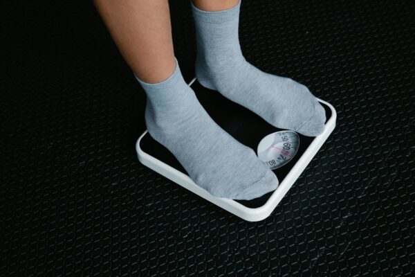 legs in socks standing on scale